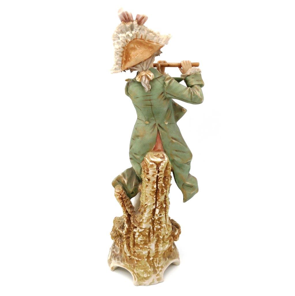 porcelánová soška značky Royal Dux, model: muž s píšťalou, bronz dekor se zlacením