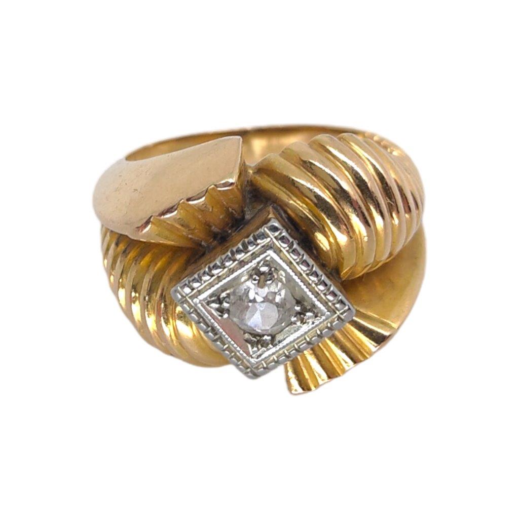 Zlatý prsten ve stylu Art Deco o ryzosti Au 740/1000 se zasazeným středovým čirým kamenem - diamantem. Celková hmotnost 6,40 g