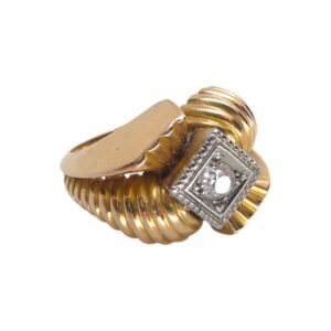 Zlatý prsten ve stylu Art Deco o ryzosti Au 740/1000 se zasazeným středovým čirým kamenem - diamantem. Celková hmotnost 6,40 g