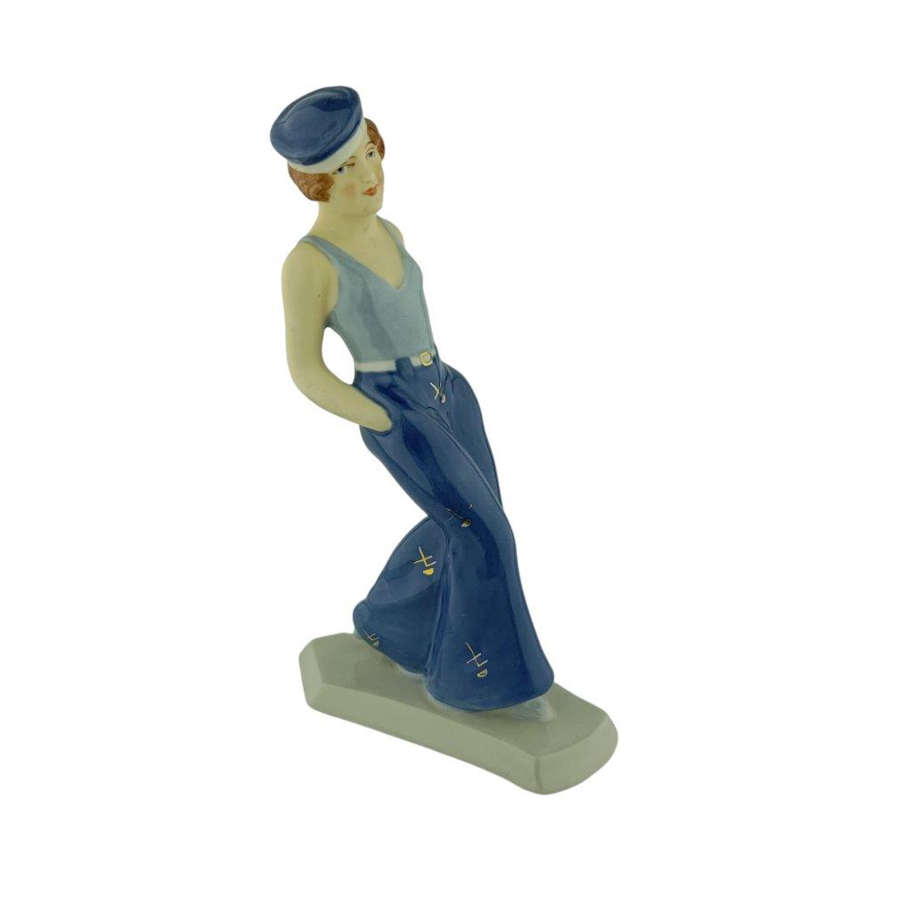 porcelánová figura značky Royal Dux, Art deco model dívky v baretu, porcelán s glazurou, modrý dekor se zlacením