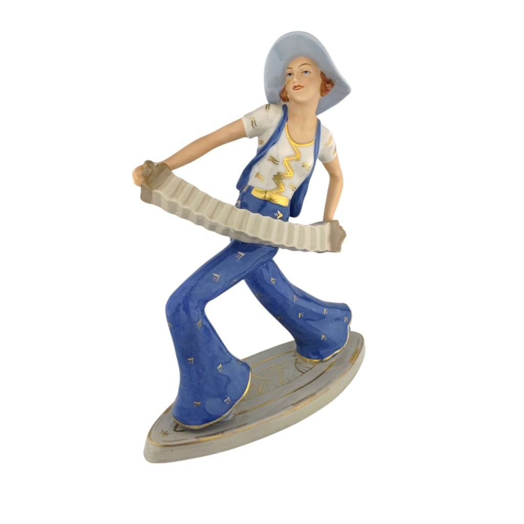 porcelánová socha značky Royal Dux, model: Harmonikářka, modrý dekor se zlacením