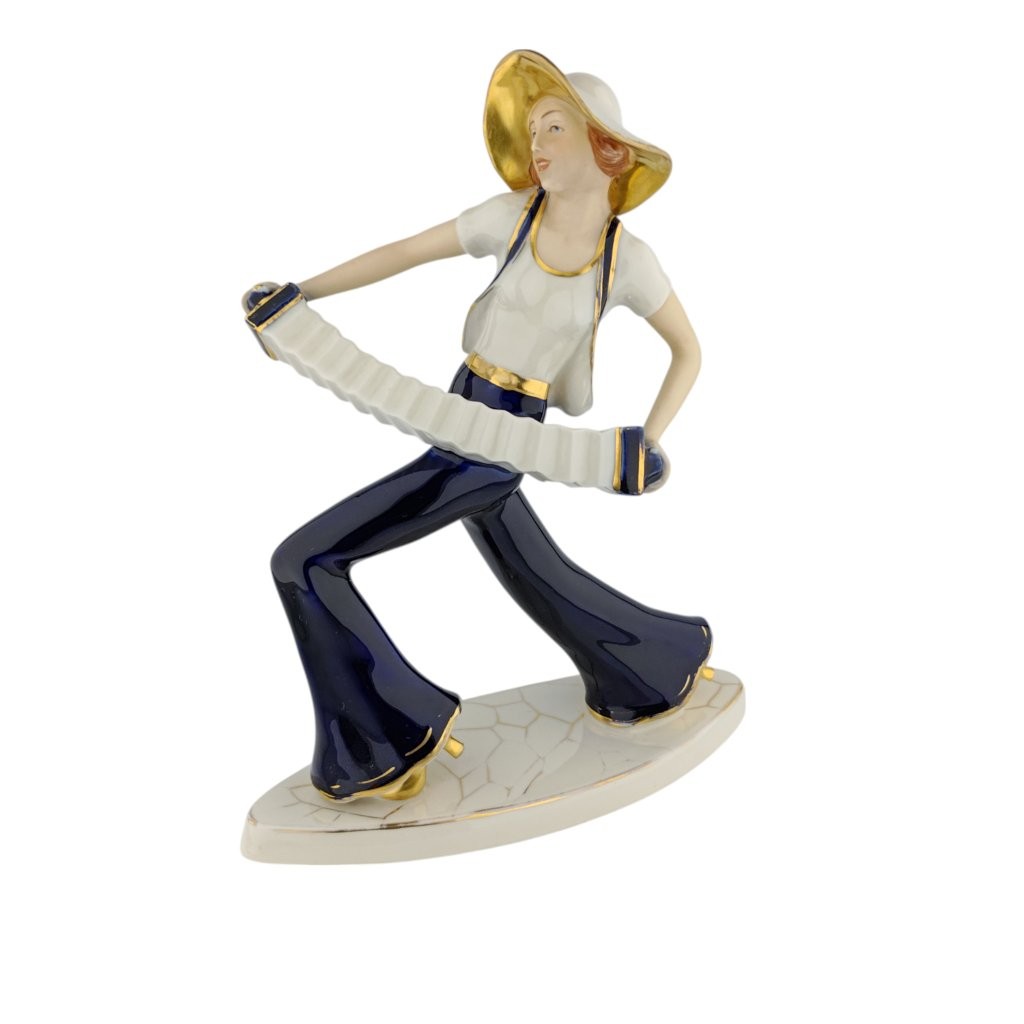 porcelánová socha značky Royal Dux, model: Harmonikářka, kobaltový dekor se zlacením