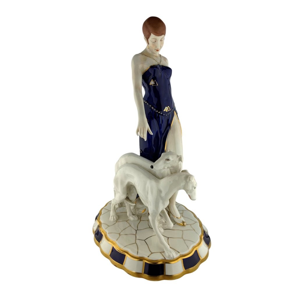 porcelánová figura značky Royal Dux, model: Art Deco žena a dva chrti, kobaltový dekor se zlacením